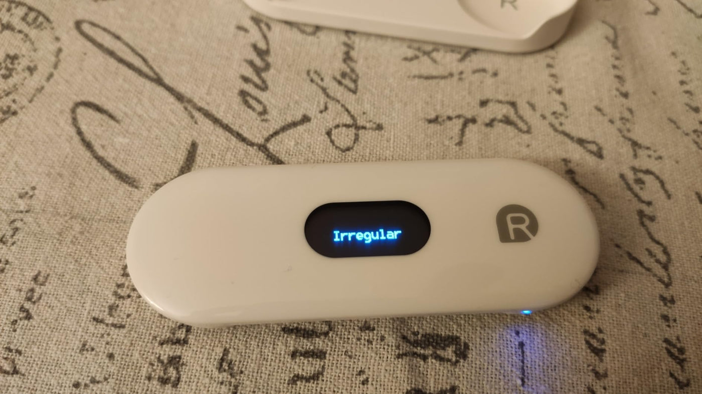 Pocket ECG monitor displaying 'Irregular' on OLED screen for health monitoring and AI analysis.