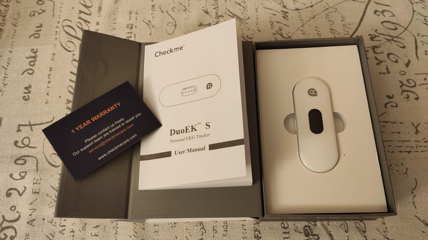 Pocket ECG monitor DuoEK S with user manual and warranty card, designed for heart health tracking.