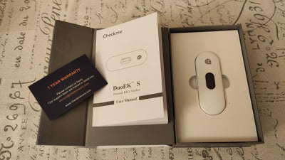 Pocket ECG monitor DuoEK S with user manual and warranty card, designed for heart health tracking.