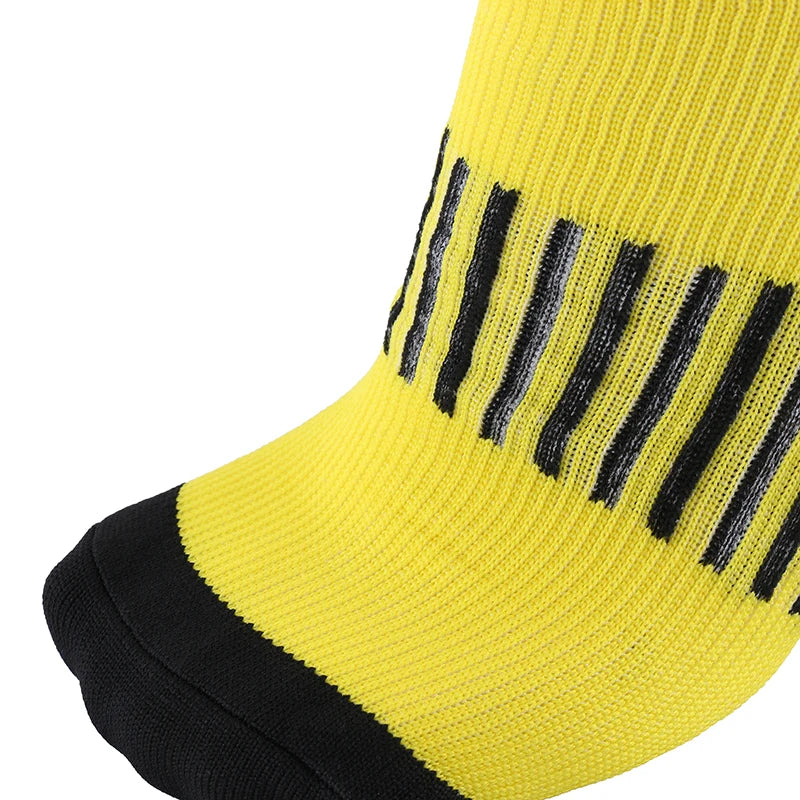 Close-up of yellow compression socks featuring geometric black stripes, ideal for sports and diabetic support.