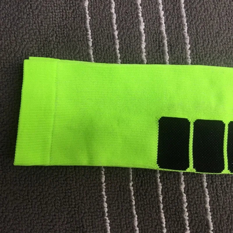 Close-up of bright green compression sock featuring a geometric pattern, ideal for sports and diabetic support.