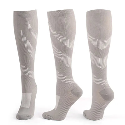 Gray compression socks for men, designed for varicose veins relief during sports, cycling, and running.