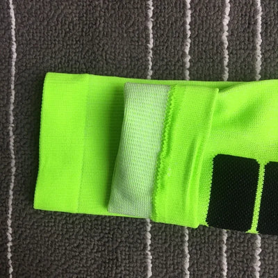 Close-up of neon green compression socks featuring geometric patterns for men and women, ideal for sports and diabetic support.