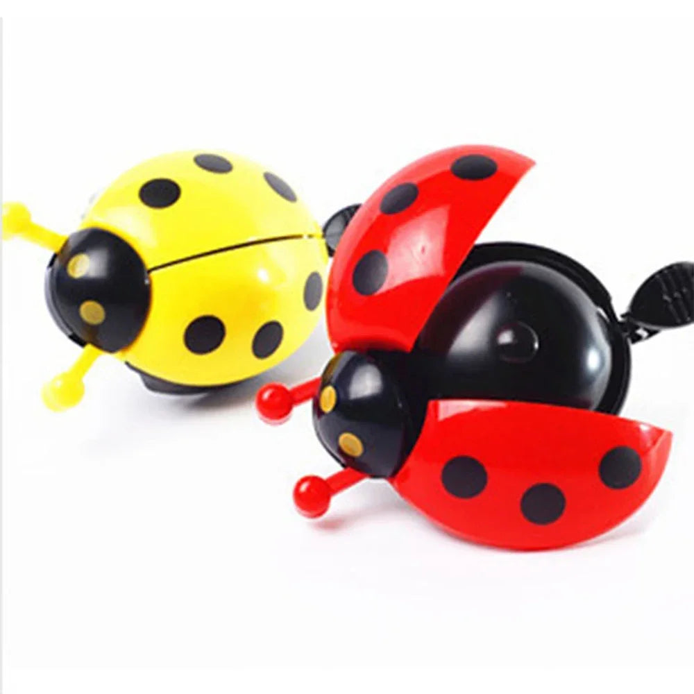 Cute cartoon ladybug bicycle bells in red and yellow, perfect mini horn for kids' bikes.