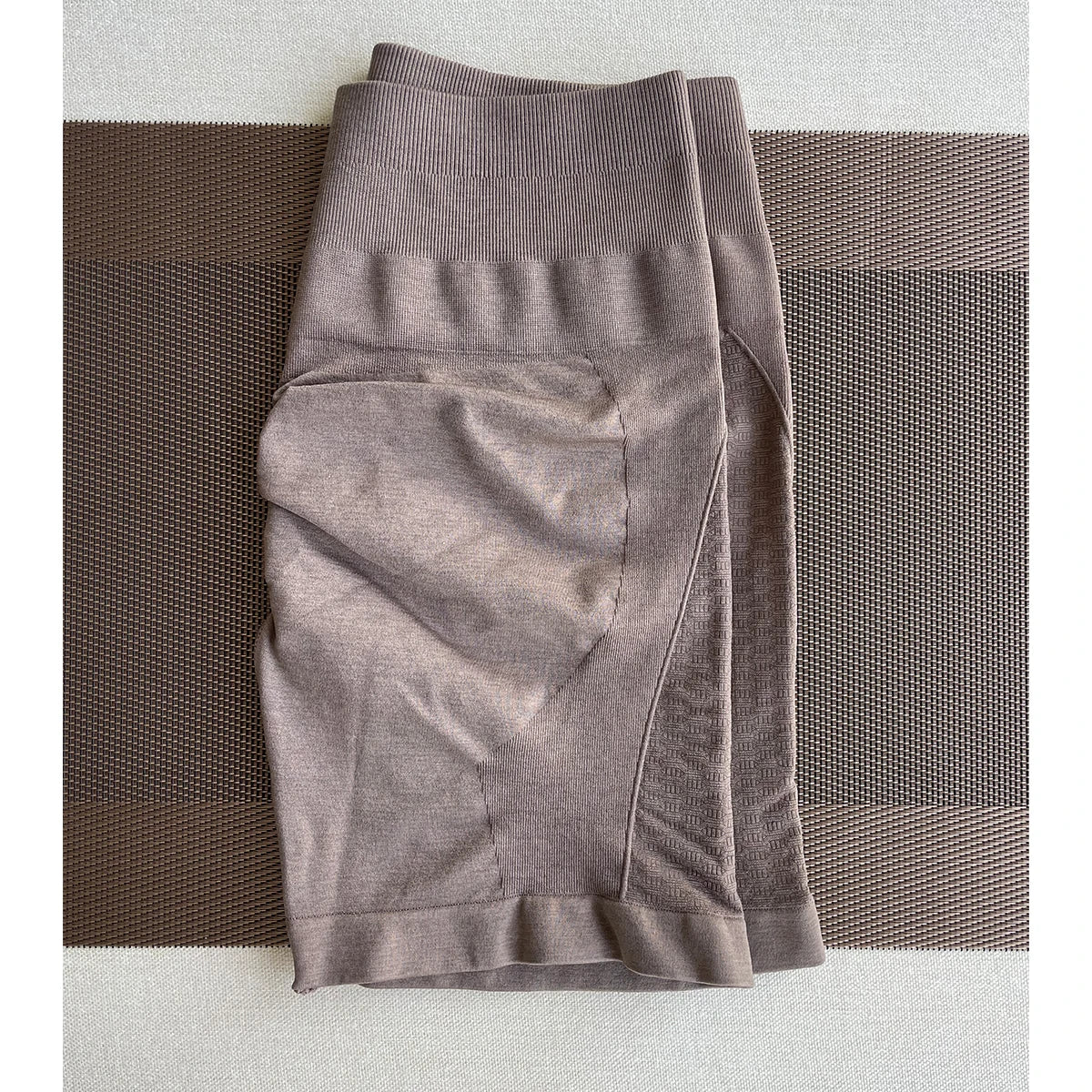 Amplify Contour Shorts for women, seamless workout pants in brown, ideal for yoga and gym wear, featuring straight pockets.