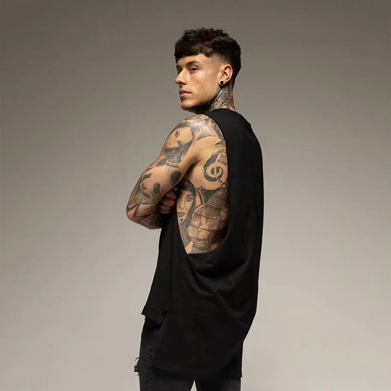 Muscular man wearing a black sleeveless cotton fitness vest, showcasing tattoos and a sporty look for gym or bodybuilding.