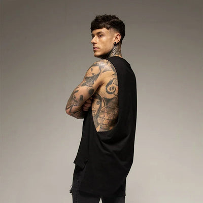 Muscular man wearing a black sleeveless cotton fitness vest, showcasing tattoos and a sporty look for gym or bodybuilding.
