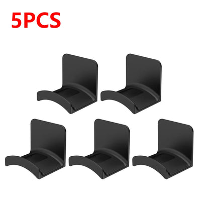 Set of 5 black adhesive headphone hangers for easy wall or desk mounting, perfect for organizing headphones.