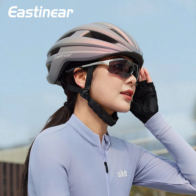 Woman wearing Eastinear ultra-light cycling helmet and sunglasses, styled for road and MTB bike safety.