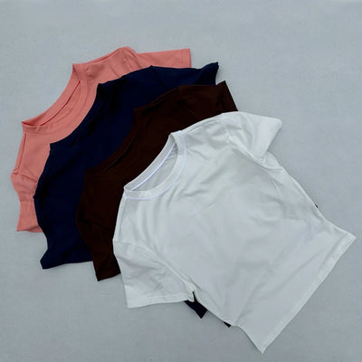 Collection of women's tight fitting sports t-shirts in various colors, ideal for yoga and fitness.