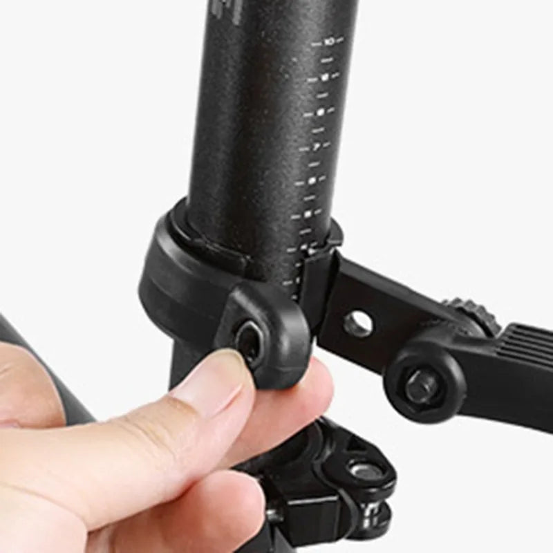 Close-up of a hand adjusting the mount on a bicycle fender for splash protection, showcasing its black soft plastic construction.