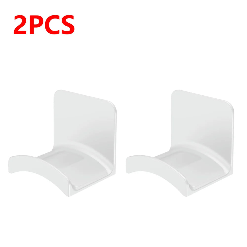 Set of 2 white adhesive headphone hangers for wall or desk mounting, designed to hold headsets securely.