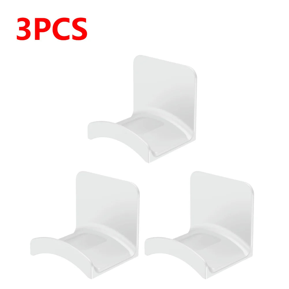 Set of 3 white adhesive headphone hangers for easy wall or desk mounting.