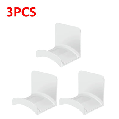 Set of 3 white adhesive headphone hangers for easy wall or desk mounting.