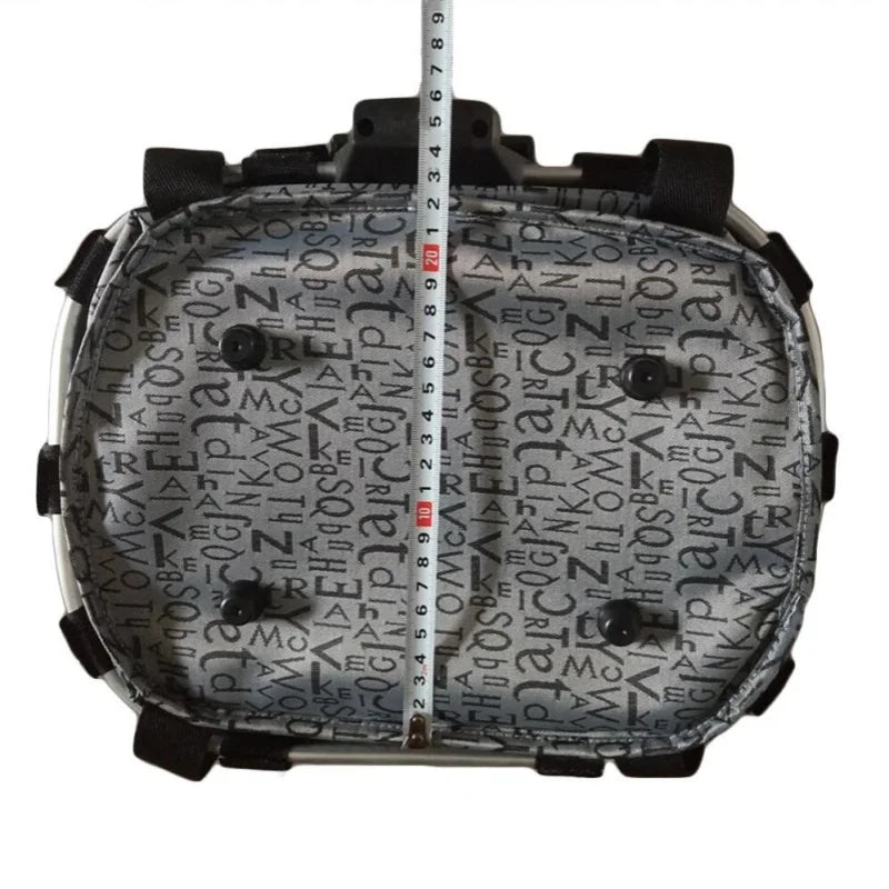 Inside view of a foldable bike front basket pet carrier with measuring tape, featuring a patterned fabric.