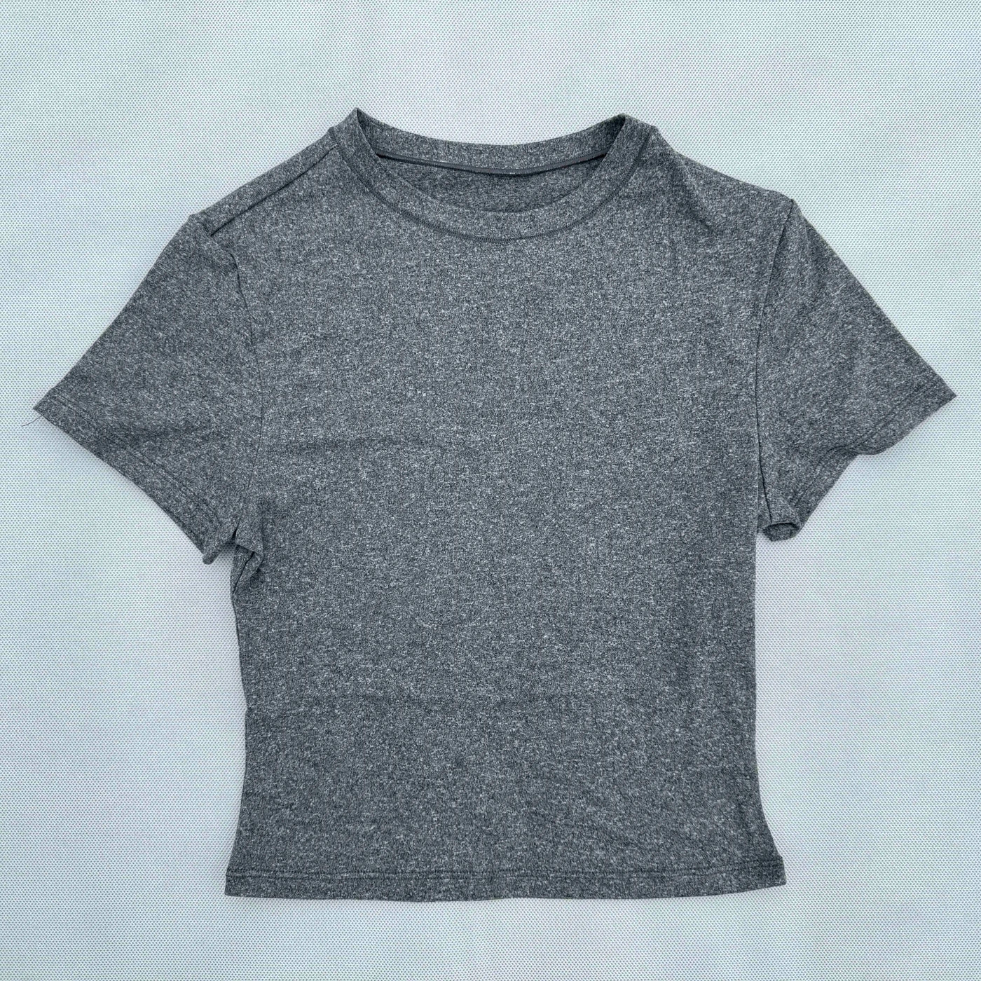 Gray women's short sleeved sports t-shirt, quick drying and breathable fabric for yoga and fitness.