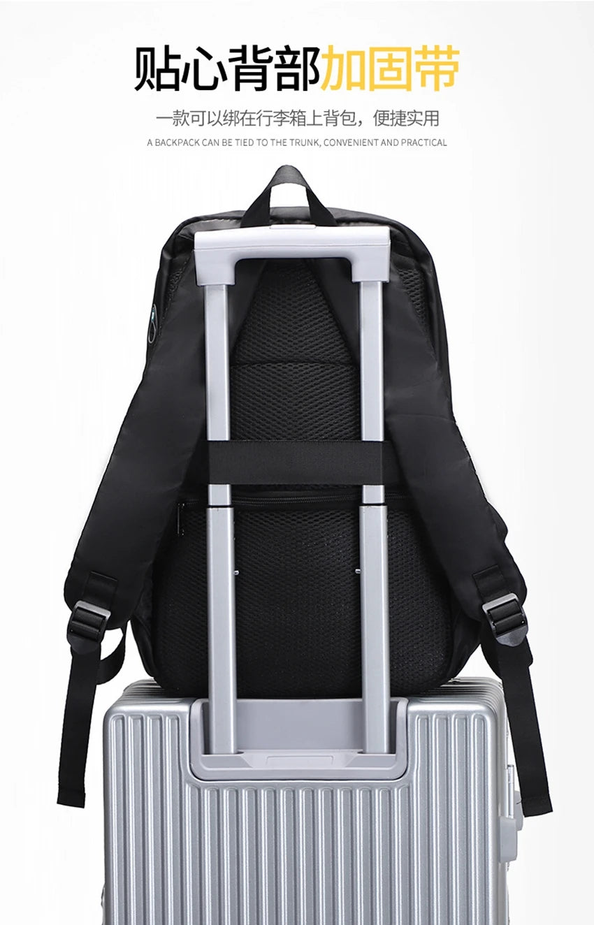 Black backpack secured on a luggage handle, showcasing practical travel design and functionality.