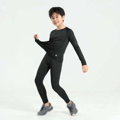 Boy wearing black thermal compression sportswear, ideal for basketball and soccer activities, showcasing flexibility and comfort.