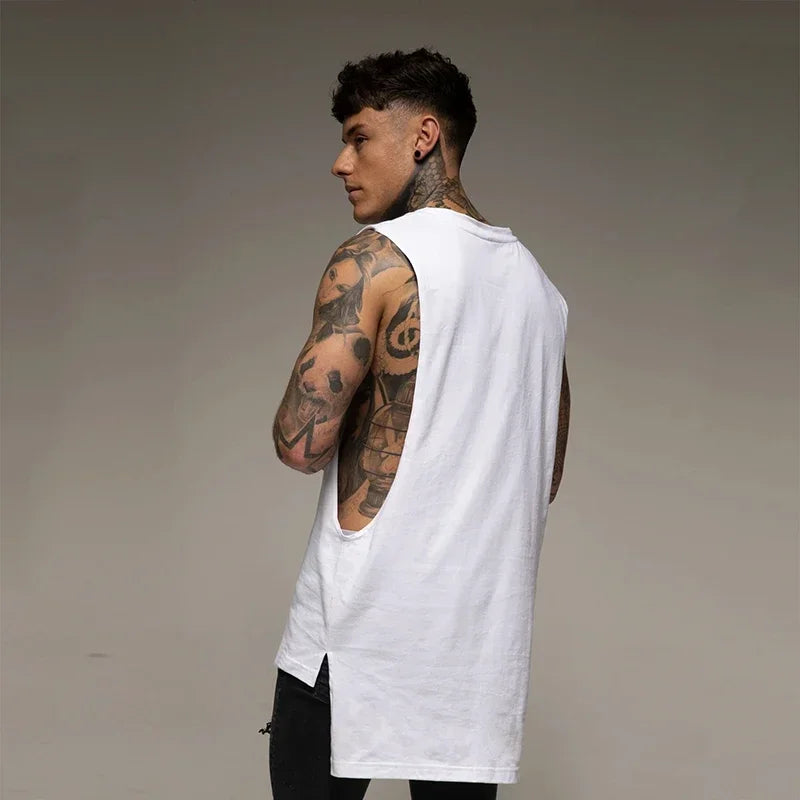 Back view of a tattooed man wearing a solid color sleeveless cotton tank top, ideal for fitness and bodybuilding.