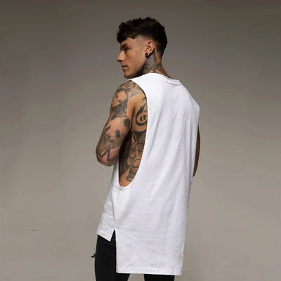 Back view of a tattooed man wearing a solid color sleeveless cotton tank top, ideal for fitness and bodybuilding.