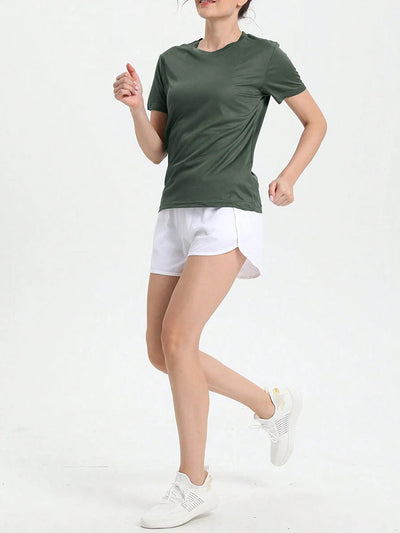Woman wearing a women's solid color ultralight quick dry sport t-shirt, perfect for running and gym activities.