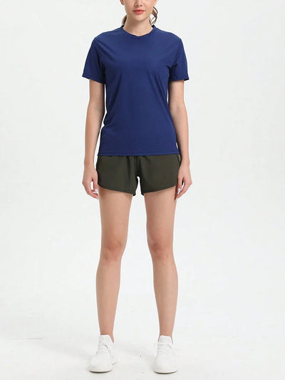 Women's ultralight quick dry sport T-shirt in navy blue, paired with green shorts, perfect for running and gym workouts.