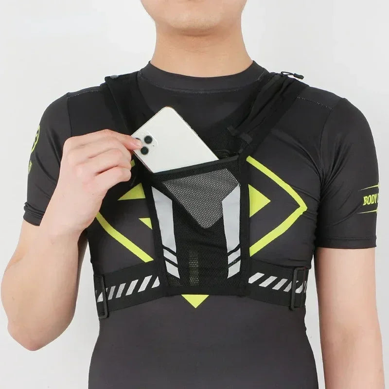 Man wearing a reflective running vest, retrieving a smartphone from the front mesh pocket.