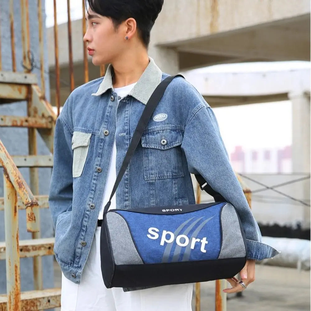 Man carrying a blue sport gym bag, wearing a denim jacket, perfect for fitness and travel.