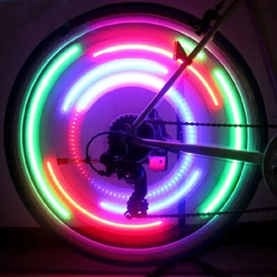 LED bicycle spoke lights illuminating a wheel with colorful patterns, enhancing road safety for cyclists.