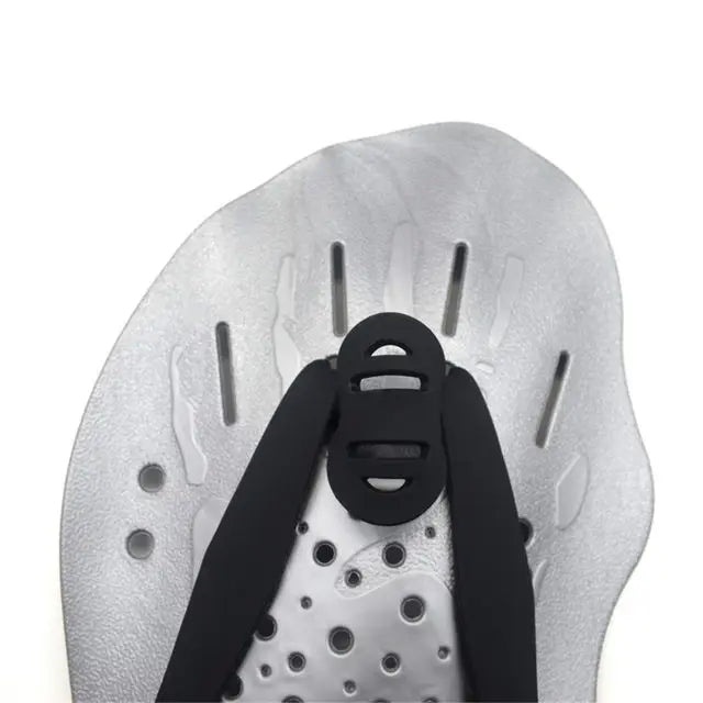 Close-up of adjustable swimming paddles featuring silicone webbed design, ideal for training adults and kids.