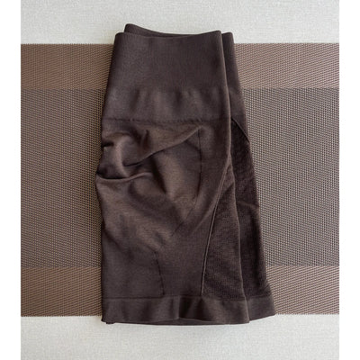 Brown nylon and spandex women's workout shorts, ideal for yoga and gym activities, featuring a seamless design.