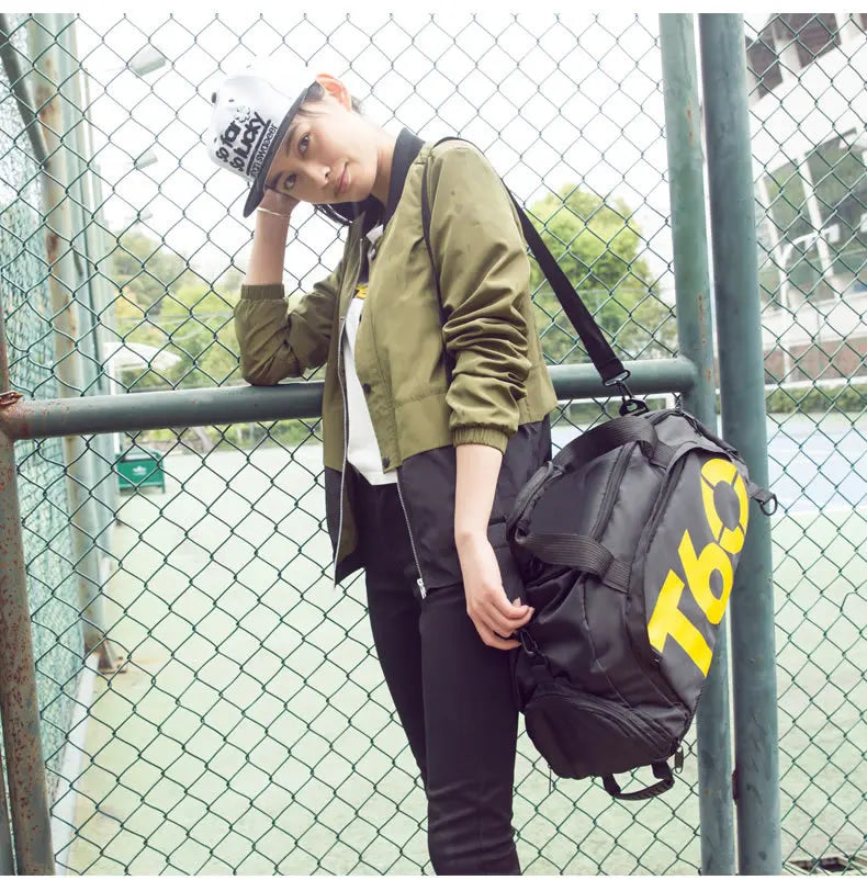 Sporty individual wearing a green jacket and cap, holding a waterproof gym bag, showcasing an active lifestyle.