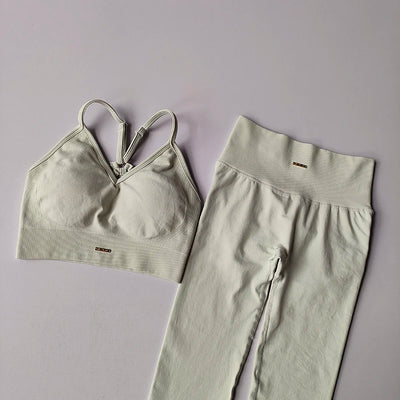 Seamless women's yoga set featuring a V-neck bra and hip-lift leggings, designed for fitness and toning.