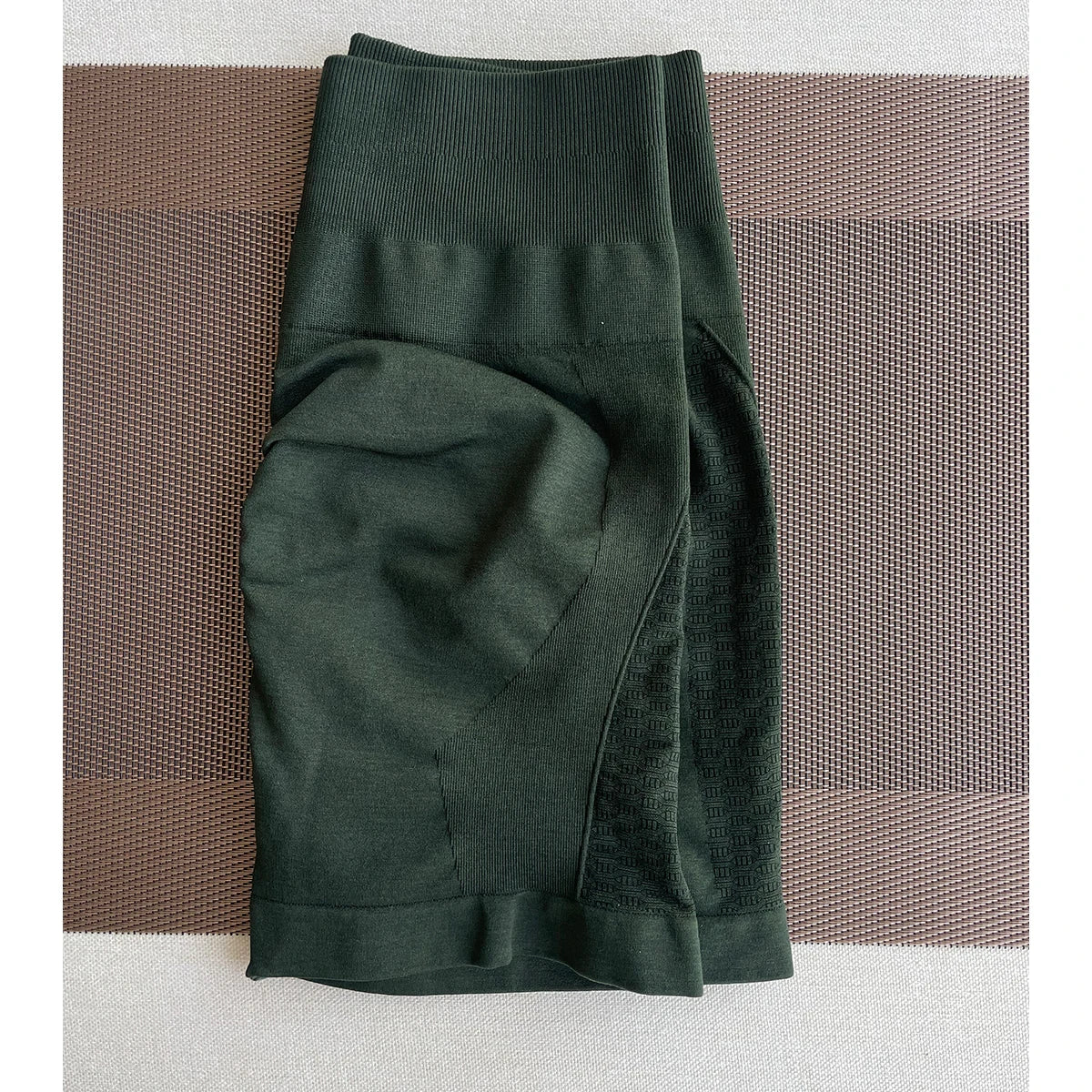 Amplify contour shorts in dark green for women, ideal for yoga and fitness, featuring seamless knit and straight pockets.