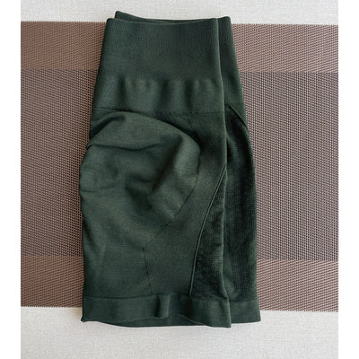 Amplify contour shorts in dark green for women, ideal for yoga and fitness, featuring seamless knit and straight pockets.