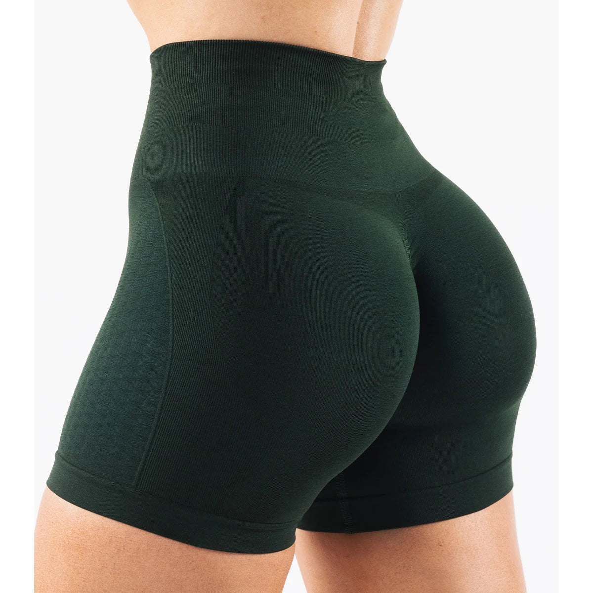Women’s green high-waisted contour shorts designed for yoga and fitness, featuring seamless knit material and straight pockets.