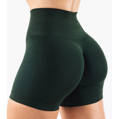 Women’s green high-waisted contour shorts designed for yoga and fitness, featuring seamless knit material and straight pockets.