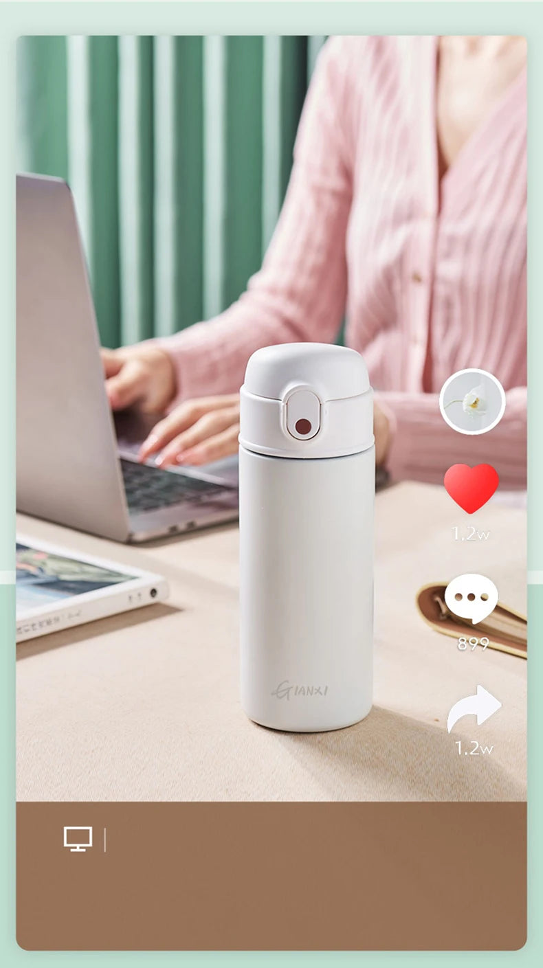GIANXI stainless steel insulated water bottle on a desk near a laptop, perfect for keeping drinks hot or cold.
