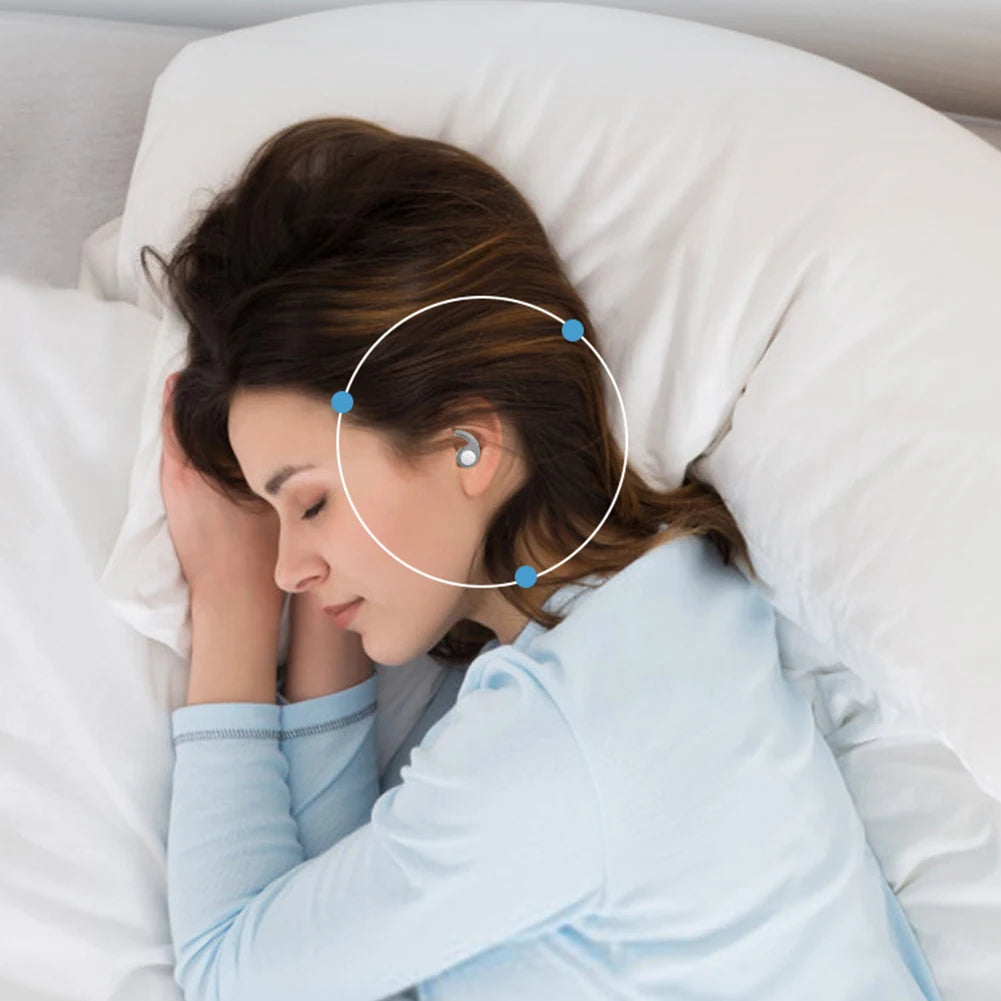 Woman sleeping peacefully with silicone earplugs in her ears on a soft pillow for noise reduction.
