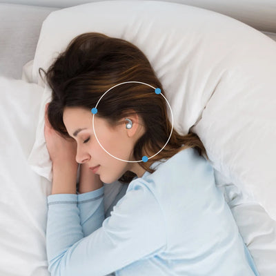 Woman sleeping peacefully with silicone earplugs in her ears on a soft pillow for noise reduction.