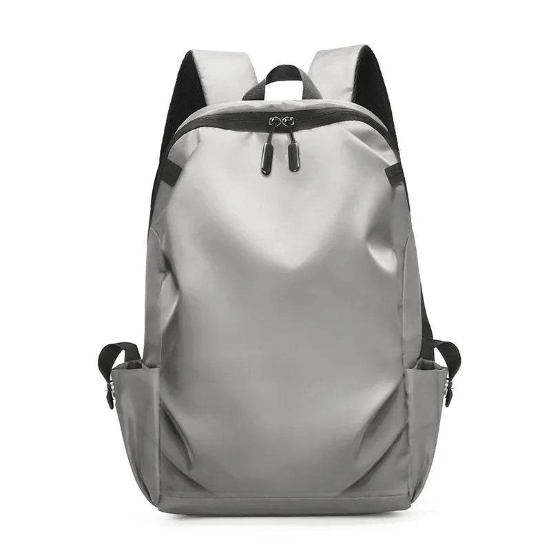 Stylish gray unisex backpack with soft straps and zipper closure, ideal for college students and daily use.