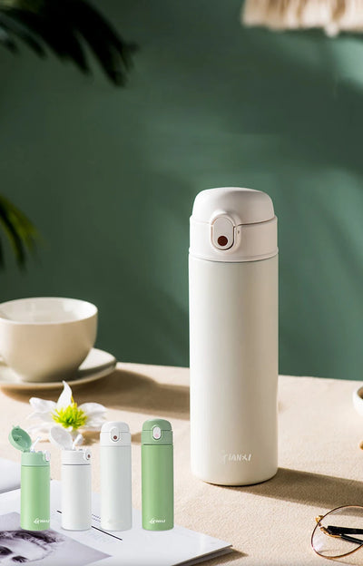GIANXI stainless steel insulated water bottle in white, showcasing vacuum flask design with colorful options on a table.