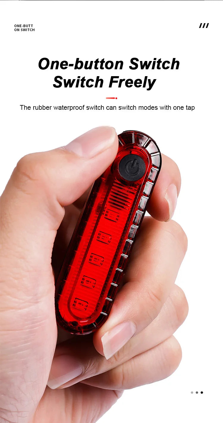 Person holding a USB rechargeable bike tail light featuring a one-button waterproof switch for easy mode changing.