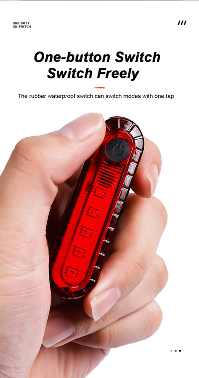 Person holding a USB rechargeable bike tail light featuring a one-button waterproof switch for easy mode changing.