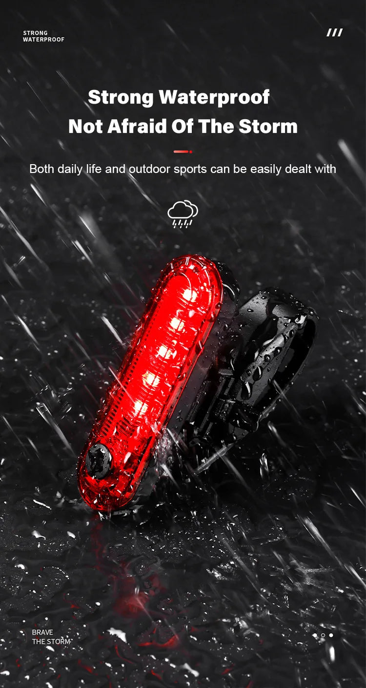 Waterproof USB rechargeable bike tail light illuminating in the rain, showcasing outdoor cycling safety.