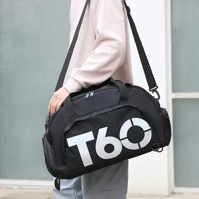 Black waterproof gym bag being carried, ideal for fitness, yoga, and outdoor activities, suitable for men and women.
