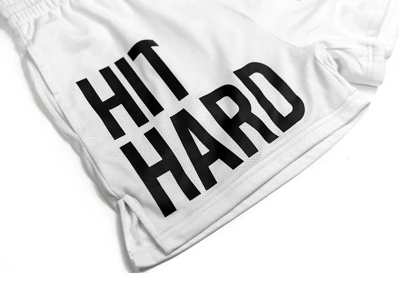 Men's white gym shorts with 'HIT HARD' printed in bold black letters, perfect for workouts and running.