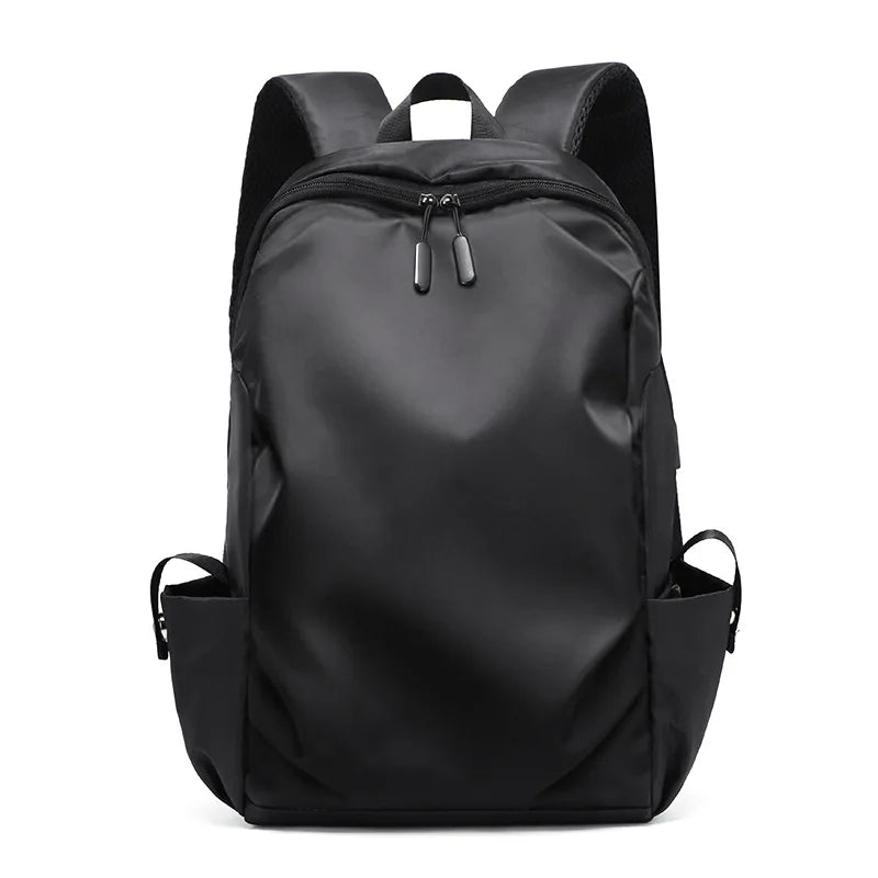 Stylish black unisex backpack with dual zipper, soft straps, and side pockets, ideal for students and daily use.