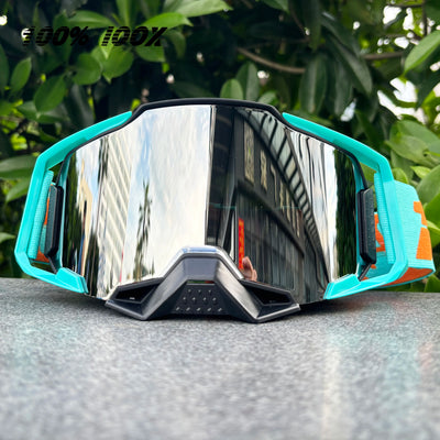 100% IOOX motorcycle and MTB goggles with mirrored lens and colorful frame, designed for off-road cycling protection.