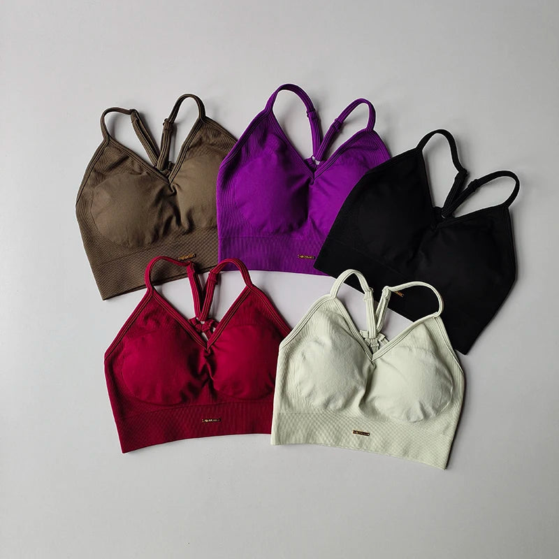 Seamless women's yoga bras in multiple colors: brown, purple, black, red, and white, perfect for fitness and toning.